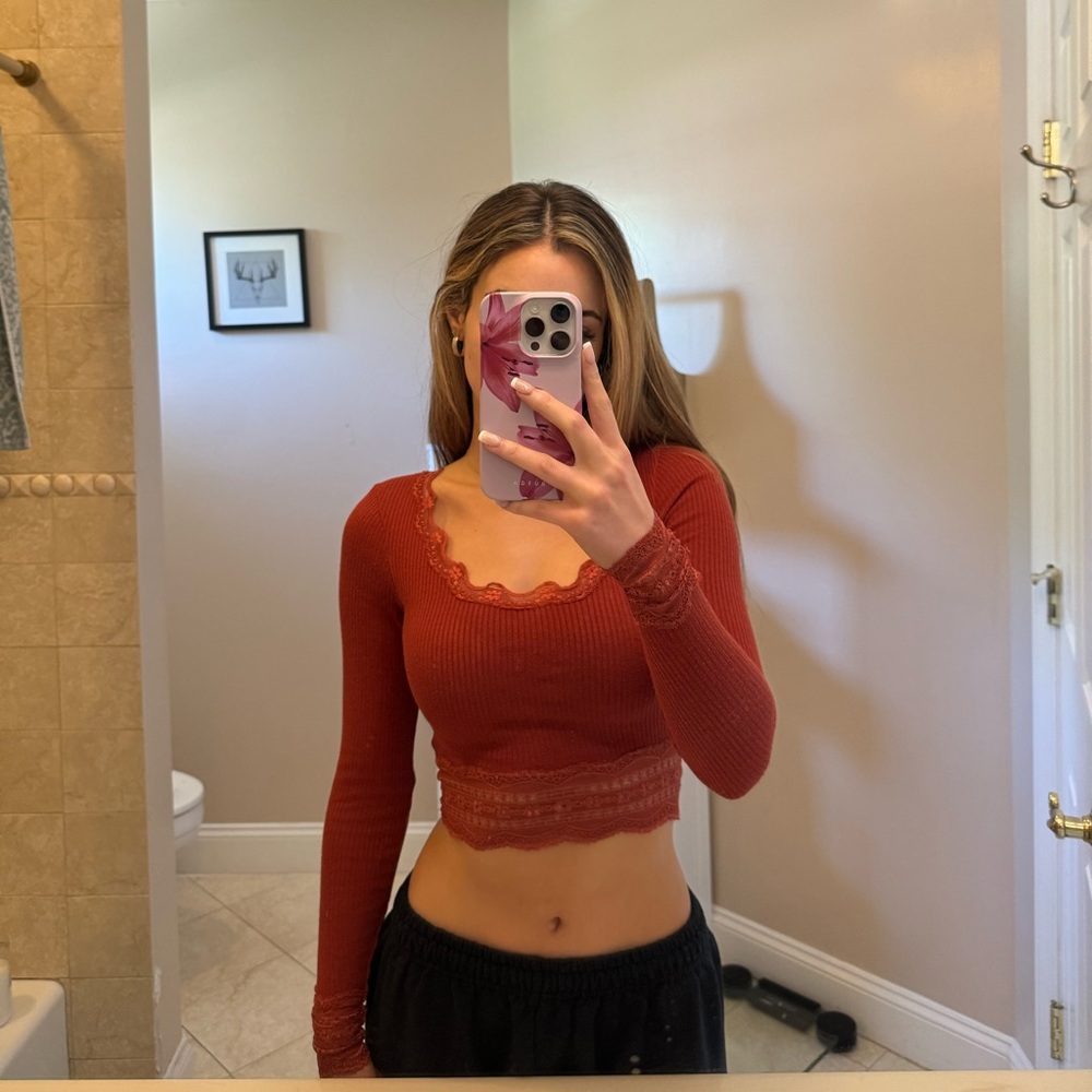 Orange long sleeve lace crop top from Urban Outfitters